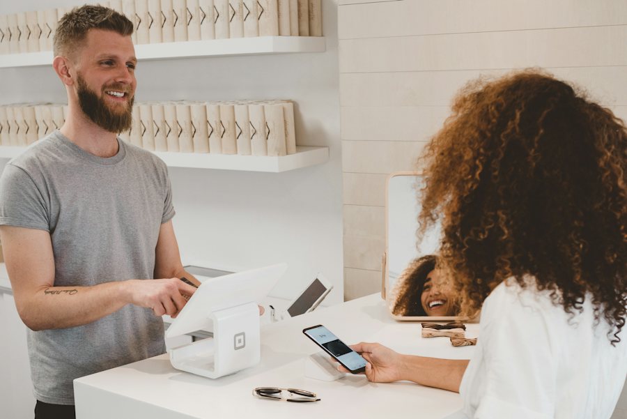 Customer paying with a phone at a modern retail counter